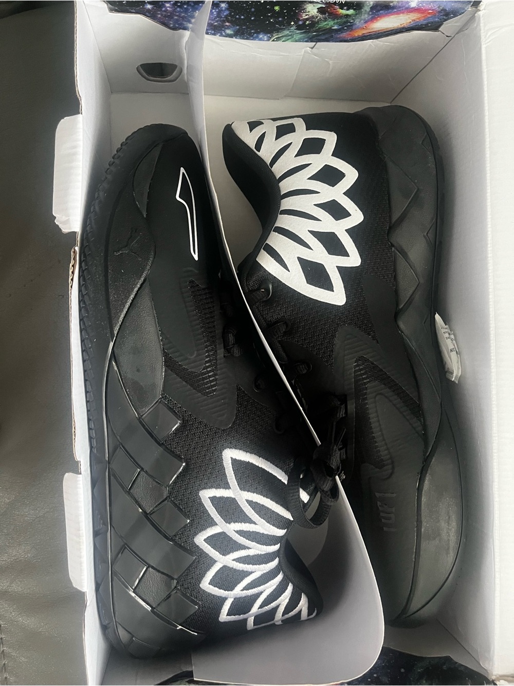 Puma Black Athletic Shoes with White Floral Accent